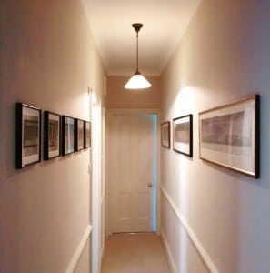 Hanging the school photos in super straight lines down the upstairs hallway