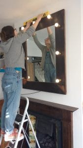 Installing a large illuminated mirror above a fireplace