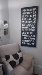 A rectangular print of thirteen addresses hung above an armchair.