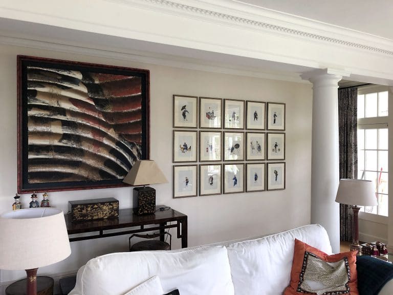 Grid of 15 frames hanging on a wall